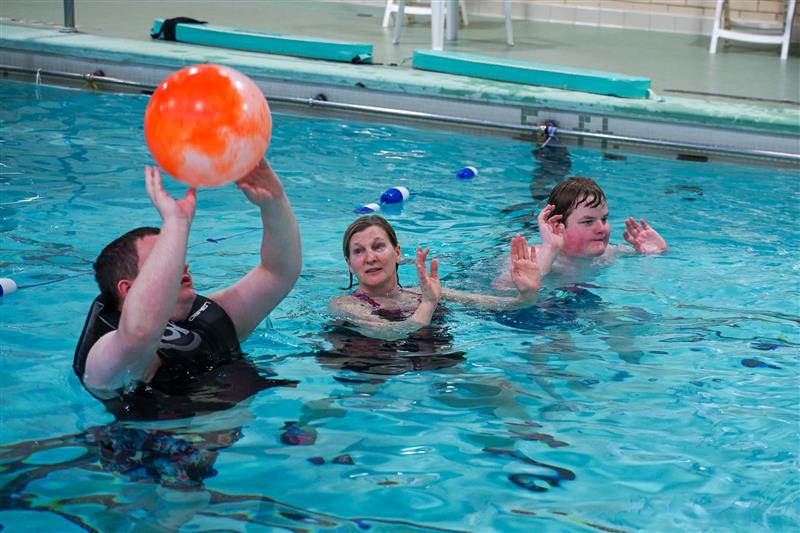 Students play water polo with Sandy Sherman (center) in the Pathfinder School Pool.